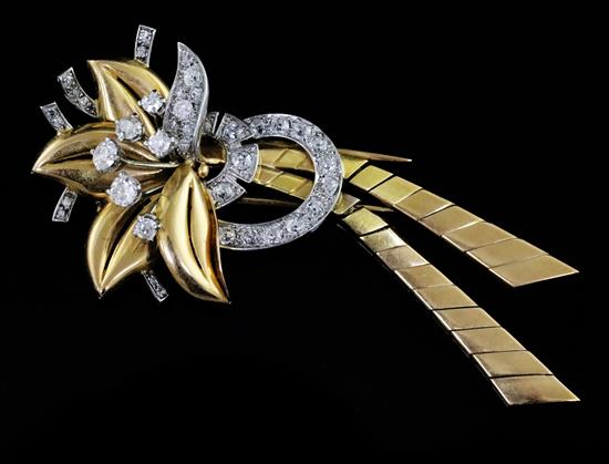 A mid 20th century French 18ct gold and diamond set stylised flower head clip brooch, 79mm.
